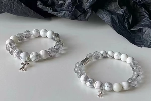 Close-up of white marble turquoise beads and black rutilated quartz with cross charms