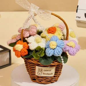 Macro shot of colorful crochet flowers in a woven basket with lace bow and pearls
