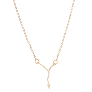 Close-up of golden Y-shaped snake chain necklace with a small gemstone detail