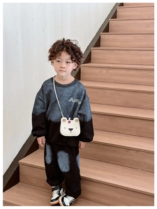 Detail of a cute white plush bear shaped crossbody bag for kids with adjustable strap