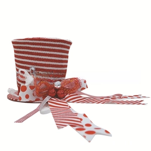 Detail of red and white striped Christmas tree top hat with ribbon bows and bells