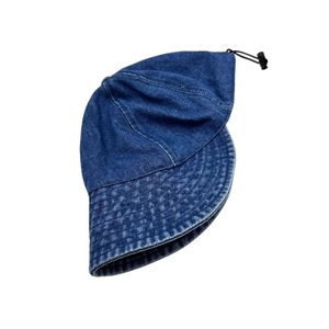 Detail of dark blue denim bucket hat showing adjustable drawstring and stitched brim