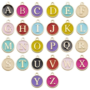 Set of 26 colorful enamel A-Z alphabet charms with gold metal frame on white background