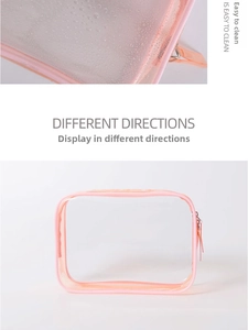 Close-up of waterproof pink PVC makeup bag surface with water droplets and easy-clean texture