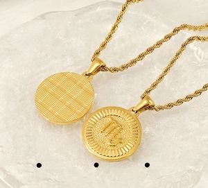 Close-up of golden Scorpio zodiac coin pendant in stainless steel with rope chain detail