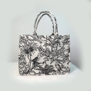 Tiger embroidery Toile de Jouy tote bag with pearl handle on white rug display