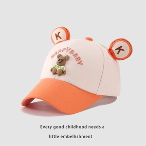 Close-up of kids baseball cap with HAPPY BABY embroidery and cute bear decoration
