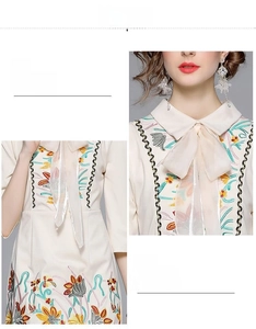 Detailed close-up of floral embroidery and silk bow neckline on this off-white dress