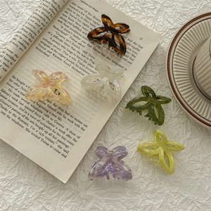 6-piece colorful acetate butterfly hair claw clips set on minimalist aesthetic background