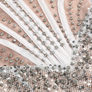 Macro detail of silver sequins and crystal rhinestones on sheer mesh party dress