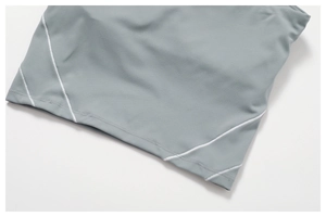 Close-up of contrast flatlock stitching on elastic grey-blue yoga set fabric