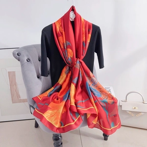 Elegant red silk-like scarf with large orange floral print and blue leaf patterns