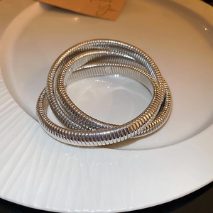 Detailed view of silver triple-layered snake bone texture elastic metal cuff bracelet