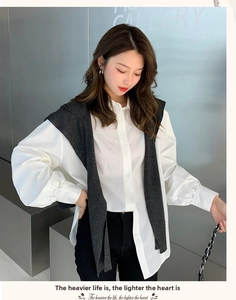 Detail of white cotton shirt paired with dark grey knit shawl and long sleeves