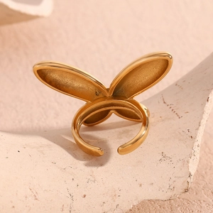 Détail d'une bague papillon en acier inoxydable plaqué or 18K sur une pierre naturelle