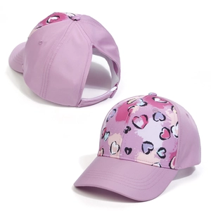 Detail view of purple ponytail baseball cap showing the large rear opening and heart pattern
