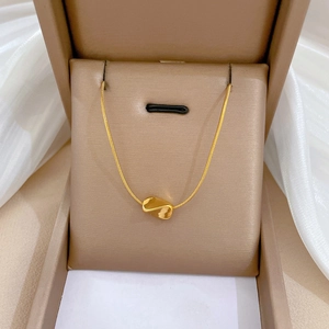 Minimalist gold bean pendant necklace made of stainless steel displayed in a jewelry box