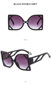 Detail view of cat eye sunglasses showing black frames and purple gradient lenses