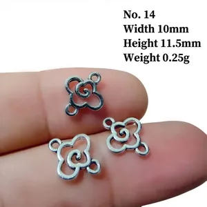Detail showing a 10x11.5mm silver alloy hollow flower connector on a finger for scale