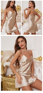 Detail of champagne gold satin slip dress showing V-neckline and smooth silk texture