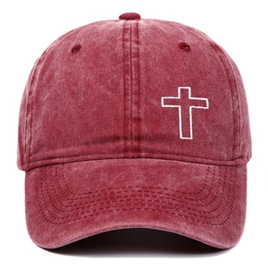 Close-up of cross embroidery on vintage washed cotton baseball cap in burgundy