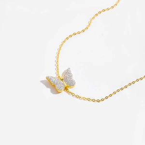 Detailed macro shot of the butterfly pendant with cubic zirconia on a gold chain