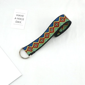 Detail of colorful geometric pattern canvas belt with silver metal D-ring buckle