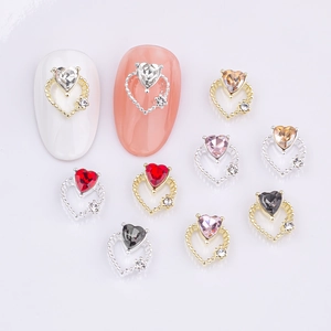 Hollow heart-shaped nail art charms with colorful gemstones and rhinestones for manicure