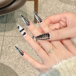 Stiletto press-on nails with black snake pattern and 3D metal snake decoration