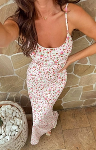 Detailed close-up of a floral summer maxi dress with delicate straps and a slim-fit design