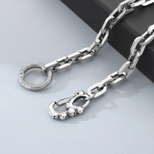 Detail of square link chain featuring skull spring clasp and snakeskin O-ring connector