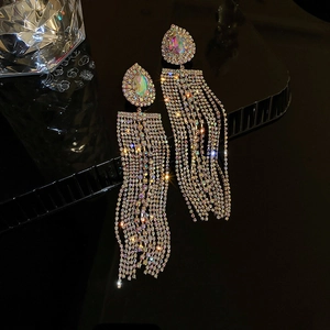 Macro view of long silver tassel earrings with iridescent water-drop rhinestones