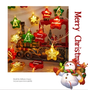 Warm glowing Christmas star string lights with festive motifs for holiday home decor.