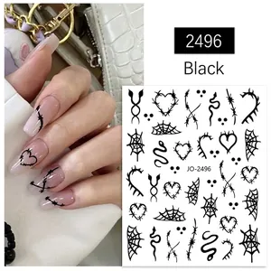 Detail of Halloween nail stickers with black spider, heart, and web patterns for nail art