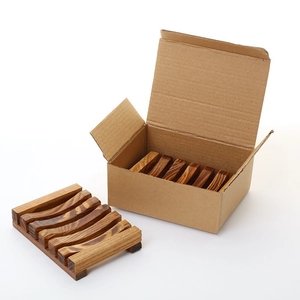 Detail of vintage charred wood soap dish set in a corrugated cardboard shipping box