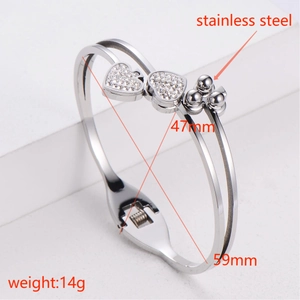 Detailed view of silver heart bracelet showing 59mm diameter and stainless steel texture