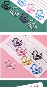 Detail of colorful duck-shaped metal paperclips in multiple vibrant shades on display cards