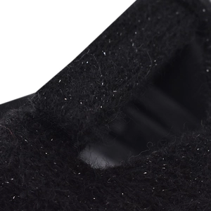 Macro shot of fluffy black plush hair claw clip with shimmering silver glitter accents