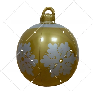 Macro detail of inflatable golden Christmas ball with white snowflake patterns and hanging ring