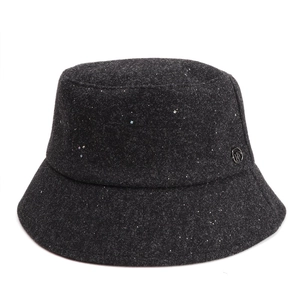 Detail of wool bucket hat with shimmering sequins and a circular metal logo ornament