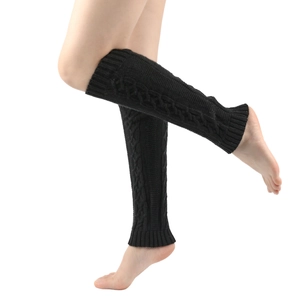 Close-up of thick cable knit texture on black leg warmers for women's winter fashion
