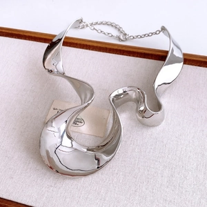 Close-up of silver wavy wide metal collar necklace with high polish finish and adjust chain