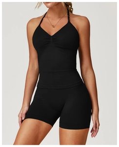 Detailed view of the black seamless halter yoga top featuring ruched chest design details