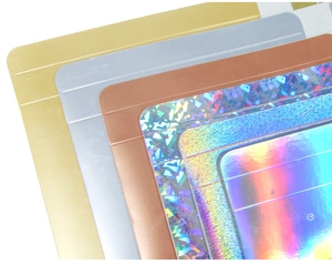 Close-up of holographic and metallic gift packaging boxes in gold and silver finishes