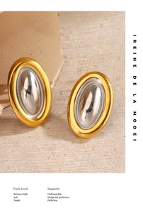 Detail of 18K gold and silver oval earrings with matte texture and mirror finish