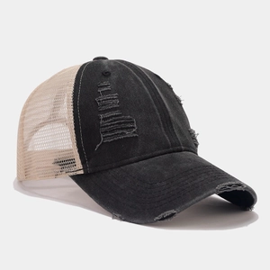 Distressed vintage trucker hat with denim front and breathable mesh back in street style