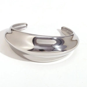 Minimalist thick silver open bangle in high-polished stainless steel with a sleek convex design
