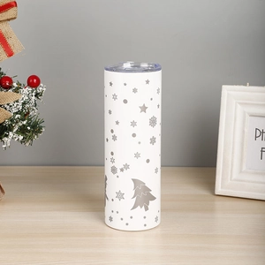 Close-up of a white 20oz stainless steel tumbler with festive Christmas tree patterns