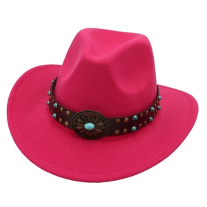 Detail of hot pink cowboy hat with leather band, turquoise beads and vintage floral buckle