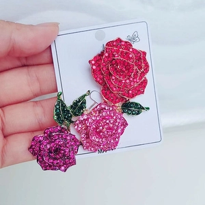 Detailed close-up of a luxury three-color rose brooch with sparkling crystal rhinestones